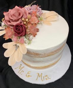 Round white wedding cake with sculpted flowers