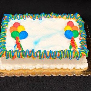 Frosted cake with balloons