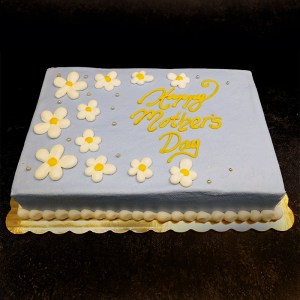 A sheet cake decorated with light blue frosting and white daisies.